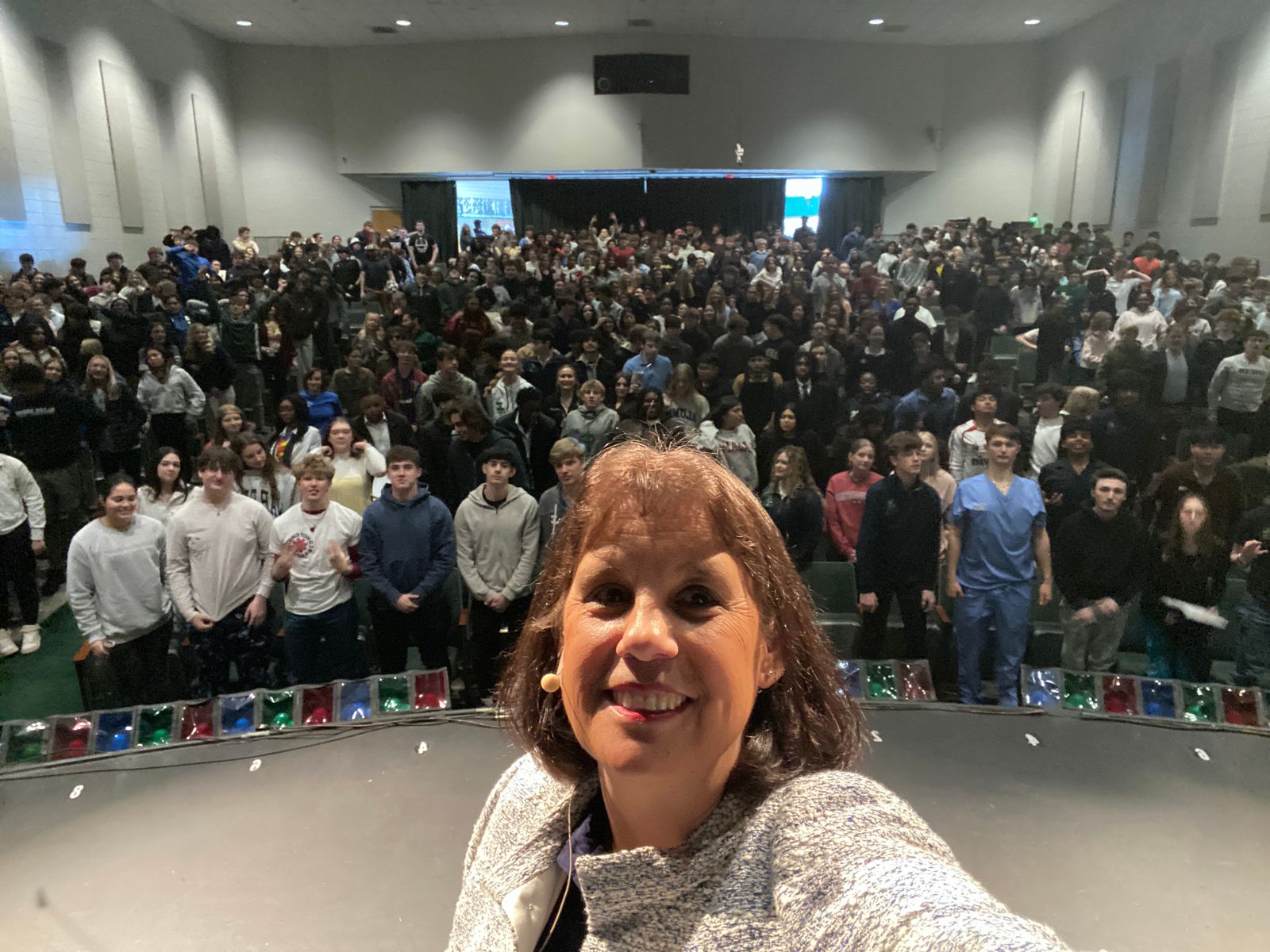 DISCOVERING AI founder Amy Love speaking to a packed parent, student, and teacher auditorium